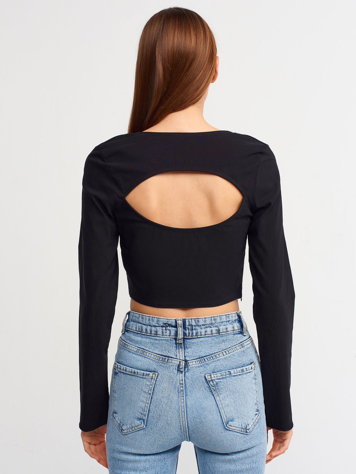 A stylish backless square neck top in a soft fabric blend, showcasing its elegant design and modern silhouette.