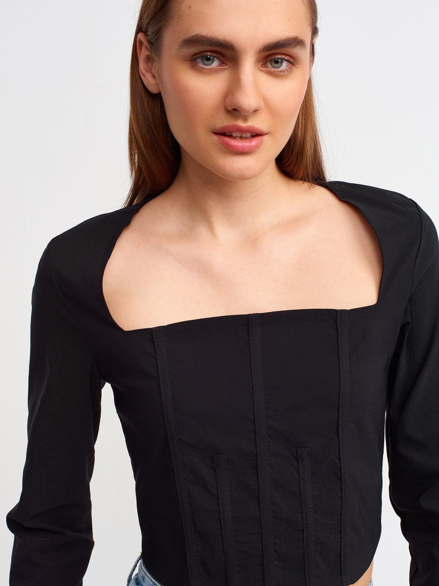 A stylish backless square neck top in a soft fabric blend, showcasing its elegant design and modern silhouette.