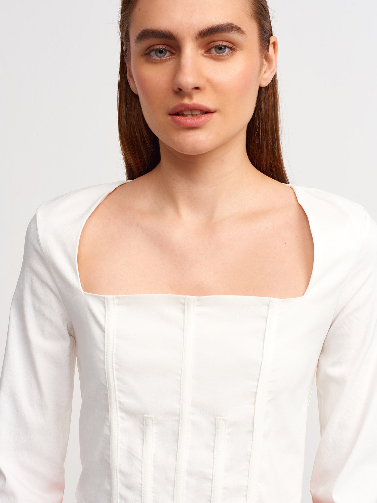 A stylish backless square neck top in a soft fabric blend, showcasing its elegant design and modern silhouette.