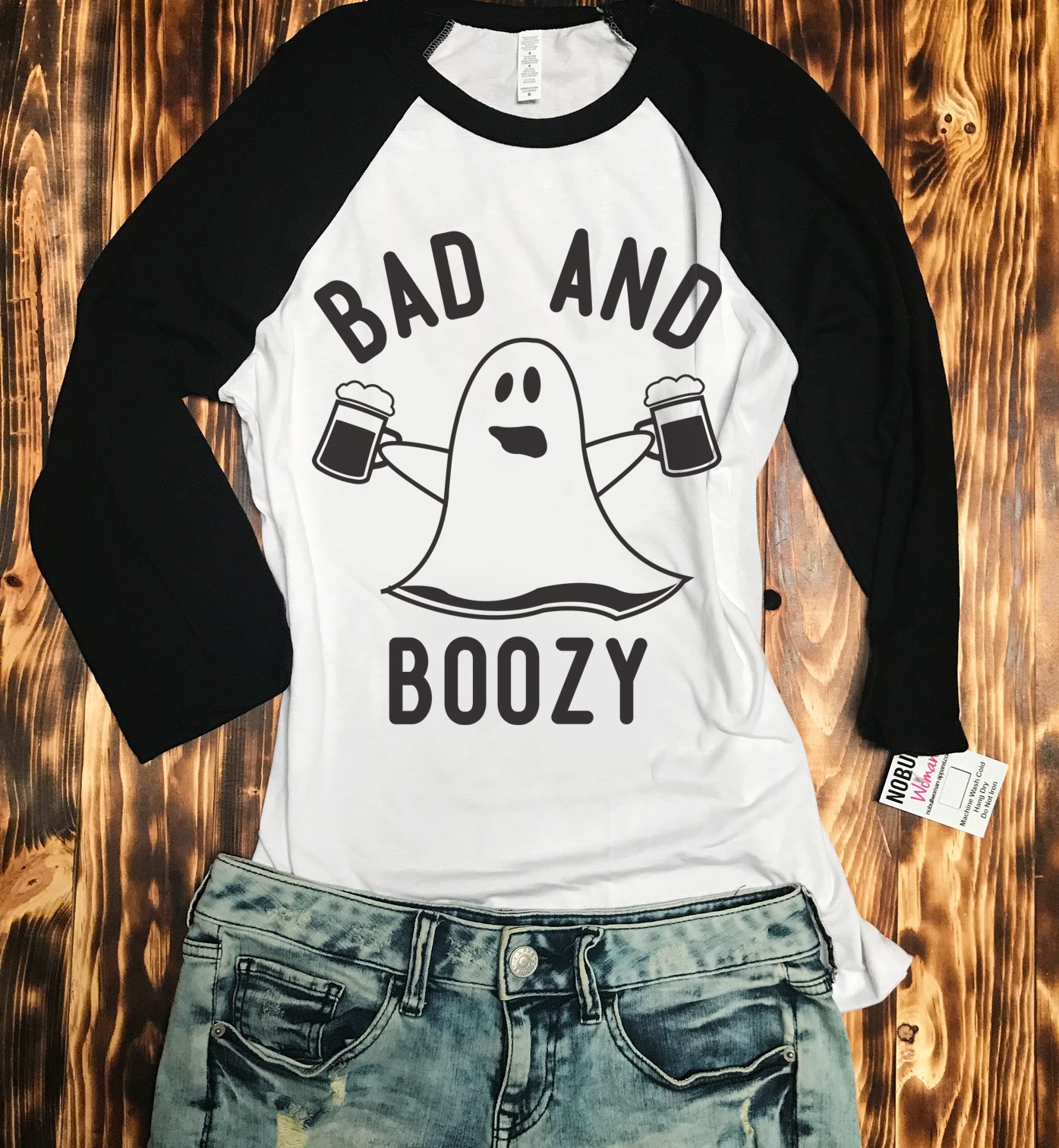 BAD & BOOZY Halloween Baseball Tee in white with black sleeves, featuring a fun graphic design perfect for Halloween celebrations.