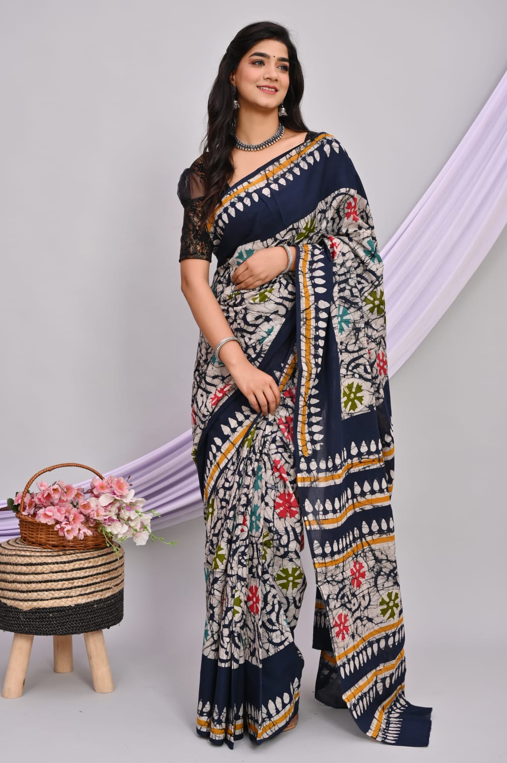 A beautiful Bagru hand block printed Kota Doria saree showcasing intricate patterns and vibrant colors, draped elegantly.