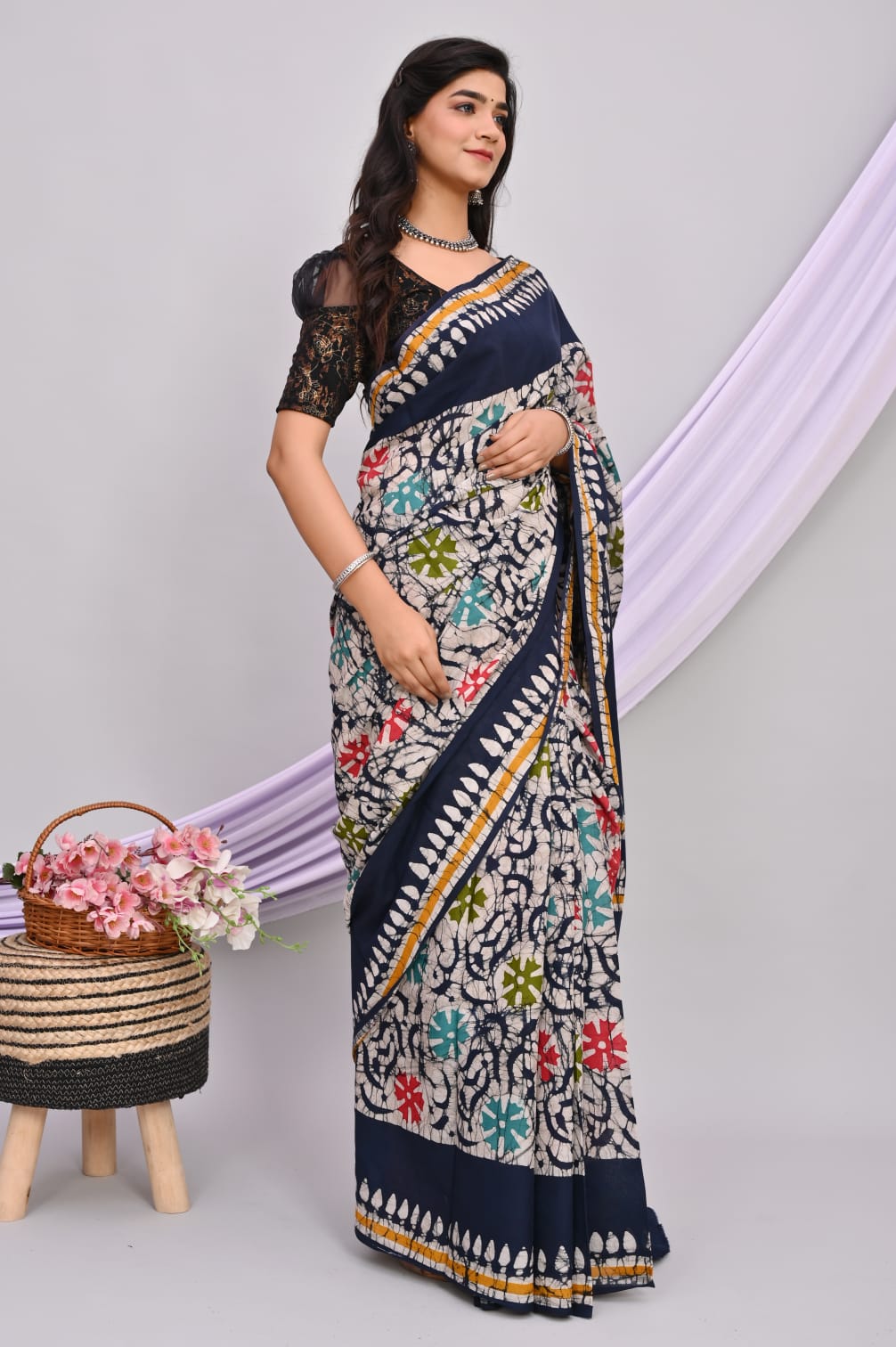 A beautiful Bagru hand block printed Kota Doria saree showcasing intricate patterns and vibrant colors, draped elegantly.