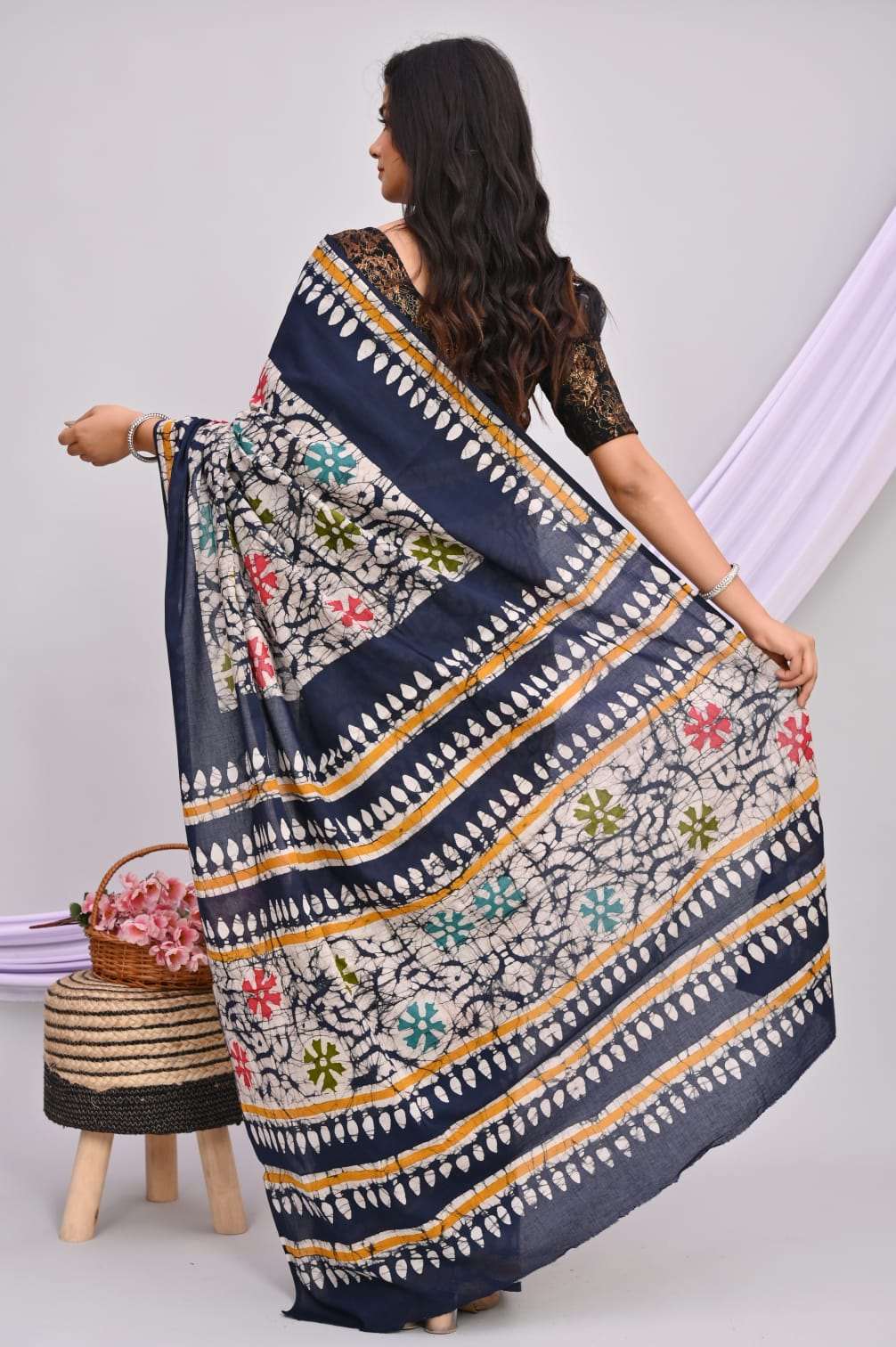 A beautiful Bagru hand block printed Kota Doria saree showcasing intricate patterns and vibrant colors, draped elegantly.