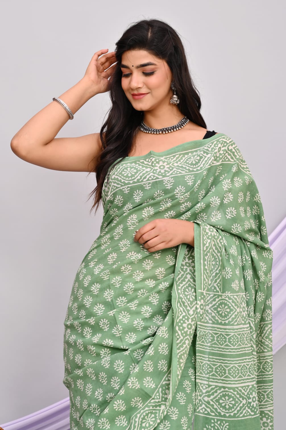 A beautiful Bagru hand block printed Kota Doria saree showcasing intricate patterns and vibrant colors, draped elegantly.