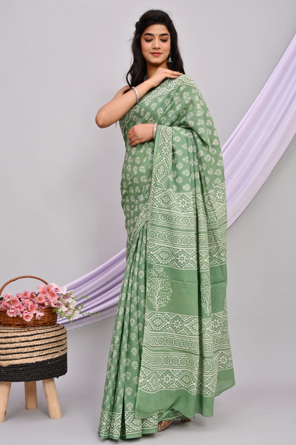 A beautiful Bagru hand block printed Kota Doria saree showcasing intricate patterns and vibrant colors, draped elegantly.