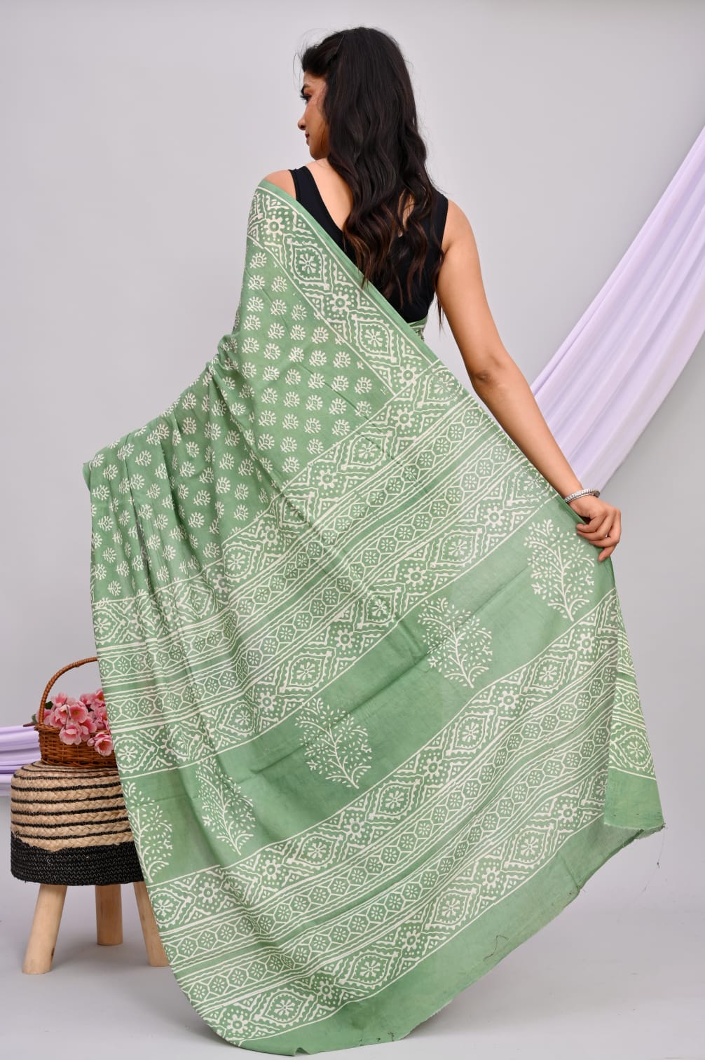 A beautiful Bagru hand block printed Kota Doria saree showcasing intricate patterns and vibrant colors, draped elegantly.