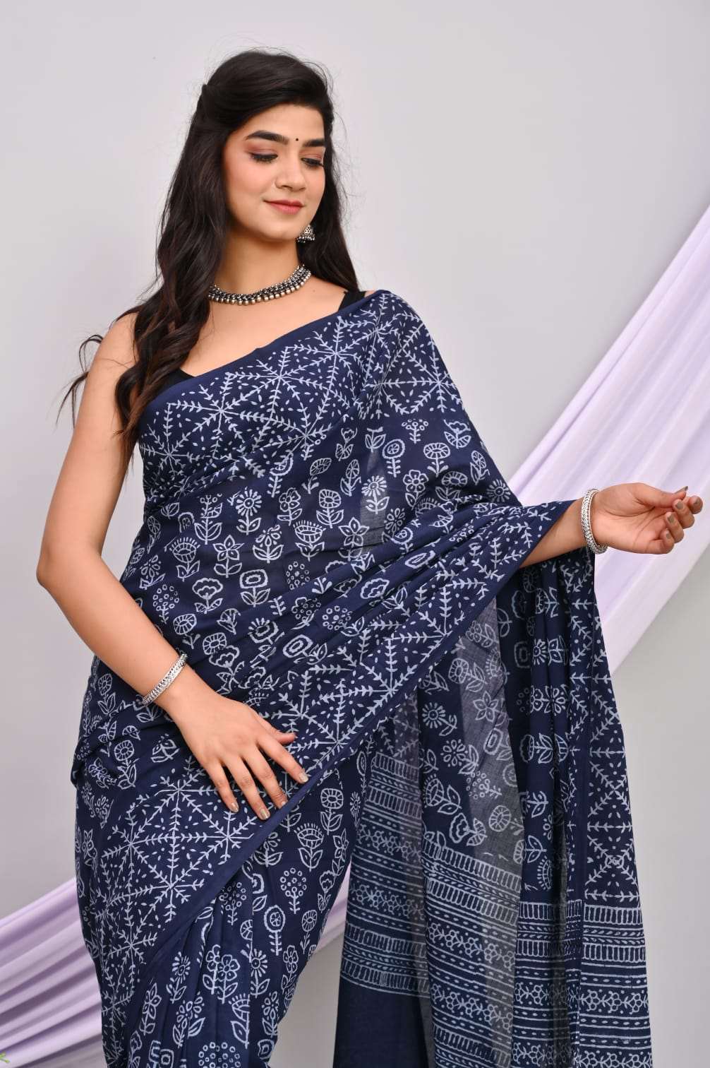 A beautiful Bagru hand block printed Kota Doria saree showcasing intricate patterns and vibrant colors, draped elegantly.