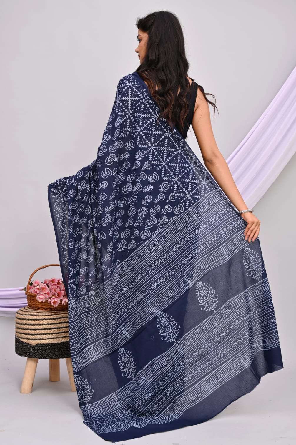 A beautiful Bagru hand block printed Kota Doria saree showcasing intricate patterns and vibrant colors, draped elegantly.