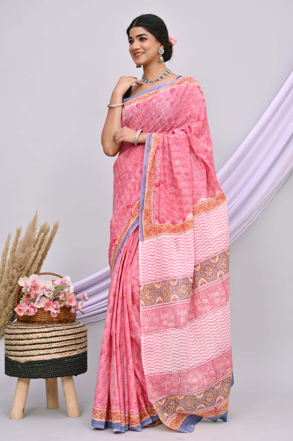 A beautiful Bagru hand block printed Kota Doria saree showcasing intricate patterns and vibrant colors, draped elegantly.