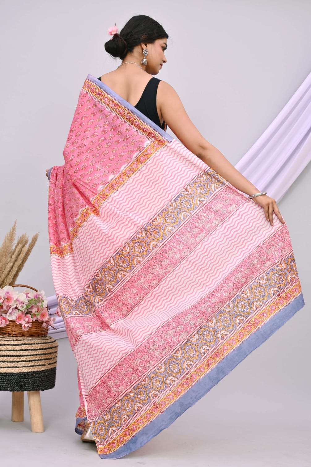 A beautiful Bagru hand block printed Kota Doria saree showcasing intricate patterns and vibrant colors, draped elegantly.