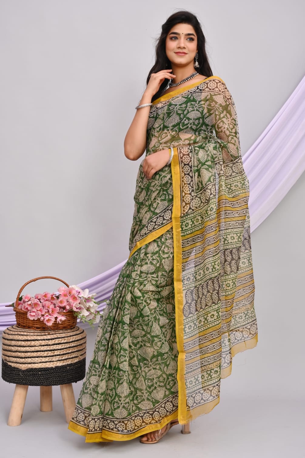 A beautiful Bagru hand block printed Kota Doria saree showcasing intricate patterns and vibrant colors, draped elegantly.