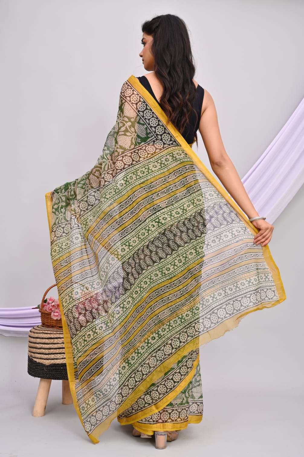 A beautiful Bagru hand block printed Kota Doria saree showcasing intricate patterns and vibrant colors, draped elegantly.