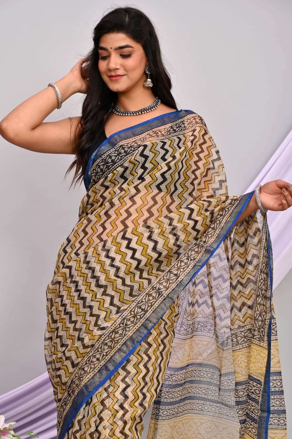 A beautiful Bagru hand block printed Kota Doria saree showcasing intricate patterns and vibrant colors, draped elegantly.