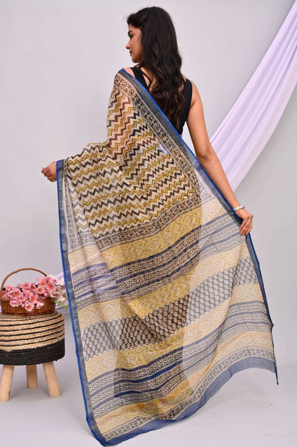 A beautiful Bagru hand block printed Kota Doria saree showcasing intricate patterns and vibrant colors, draped elegantly.