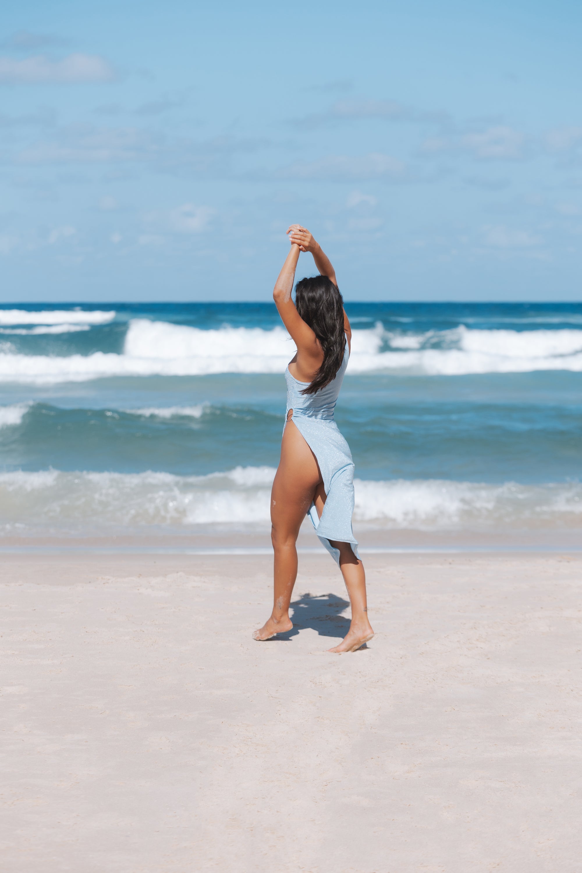 A beautiful baby blue shimmer dress with a one-shoulder design and ring detailing, showcasing its elegant allure and bodycon fit.