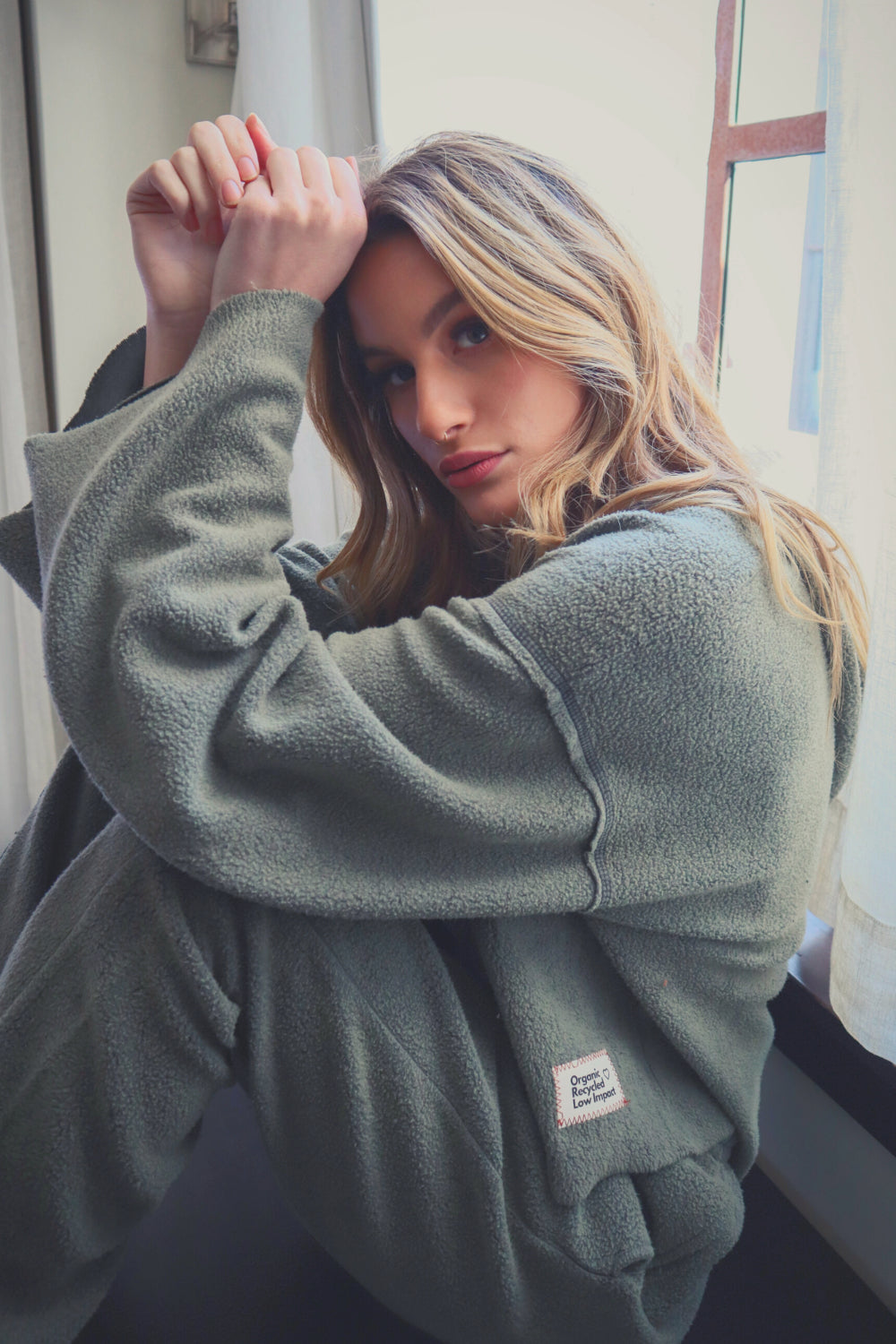 Baja Hoodie in sage green, showcasing its boxy silhouette and eco-friendly fabric, perfect for casual wear.