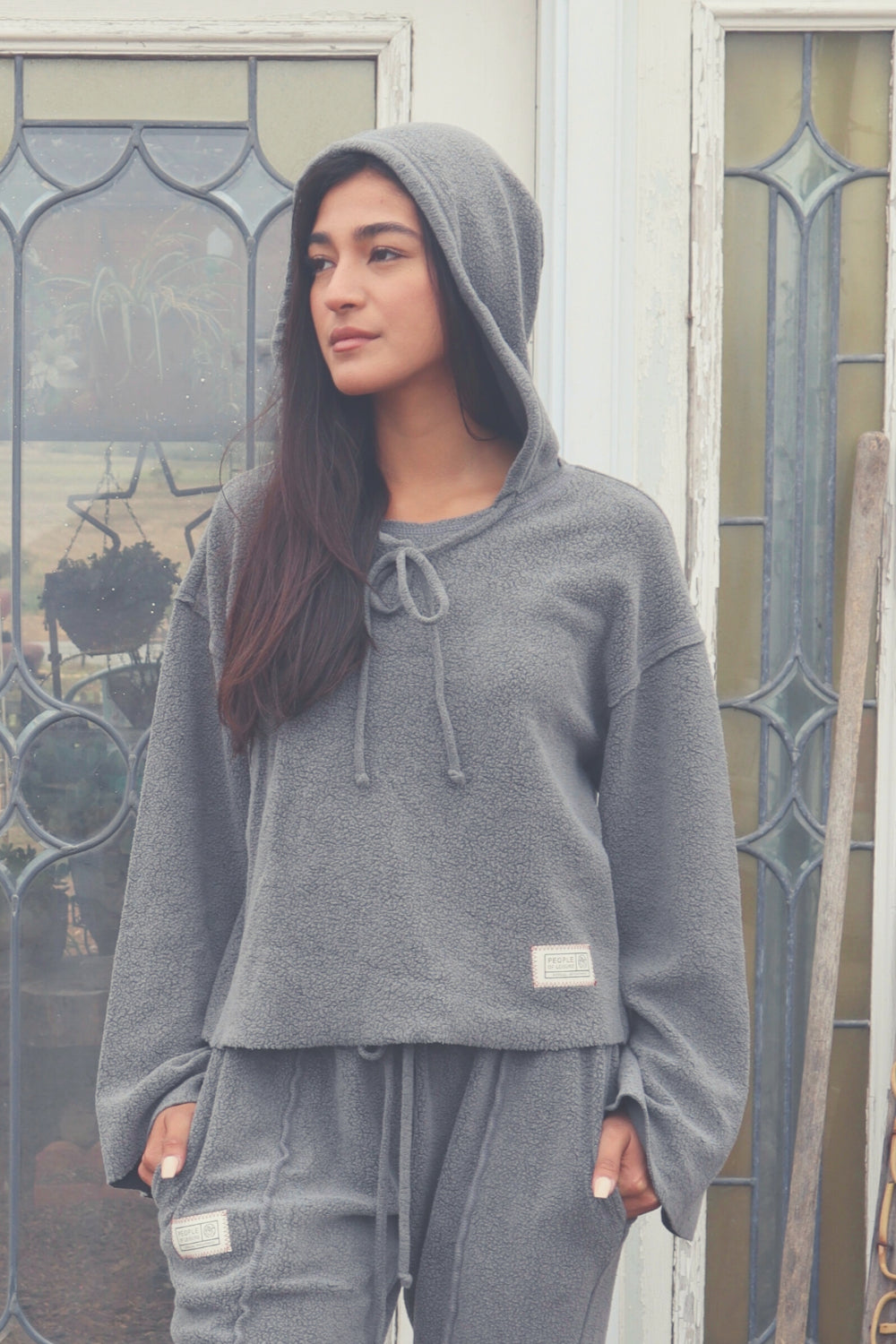 Baja Hoodie in sage green, showcasing its boxy silhouette and eco-friendly fabric, perfect for casual wear.