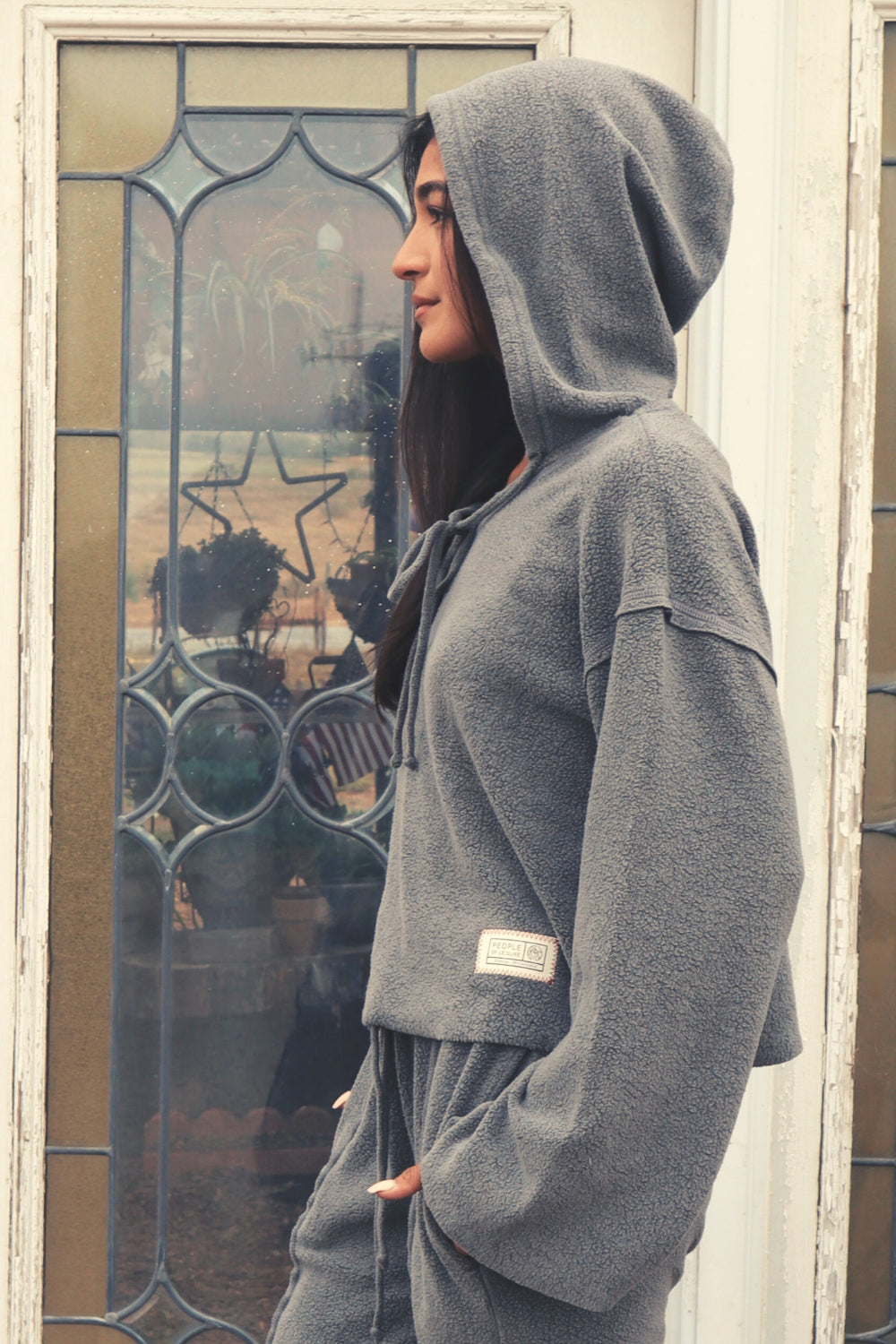 Baja Hoodie in sage green, showcasing its boxy silhouette and eco-friendly fabric, perfect for casual wear.