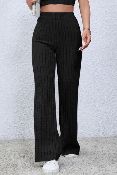 Basic Bae Full Size Ribbed High Waist Flare Pants in black, showcasing ribbed texture and high waist design.