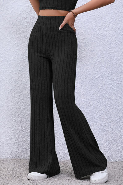 Basic Bae Full Size Ribbed High Waist Flare Pants in black, showcasing ribbed texture and high waist design.