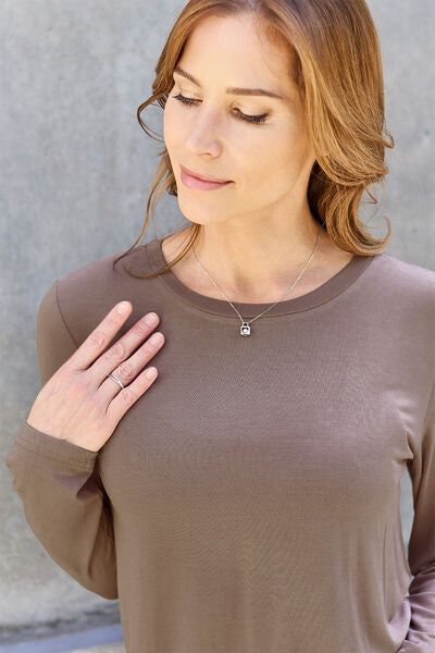 Basic Bae Full Size Round Neck Long Sleeve Top in various sizes, showcasing its classic design and soft fabric.