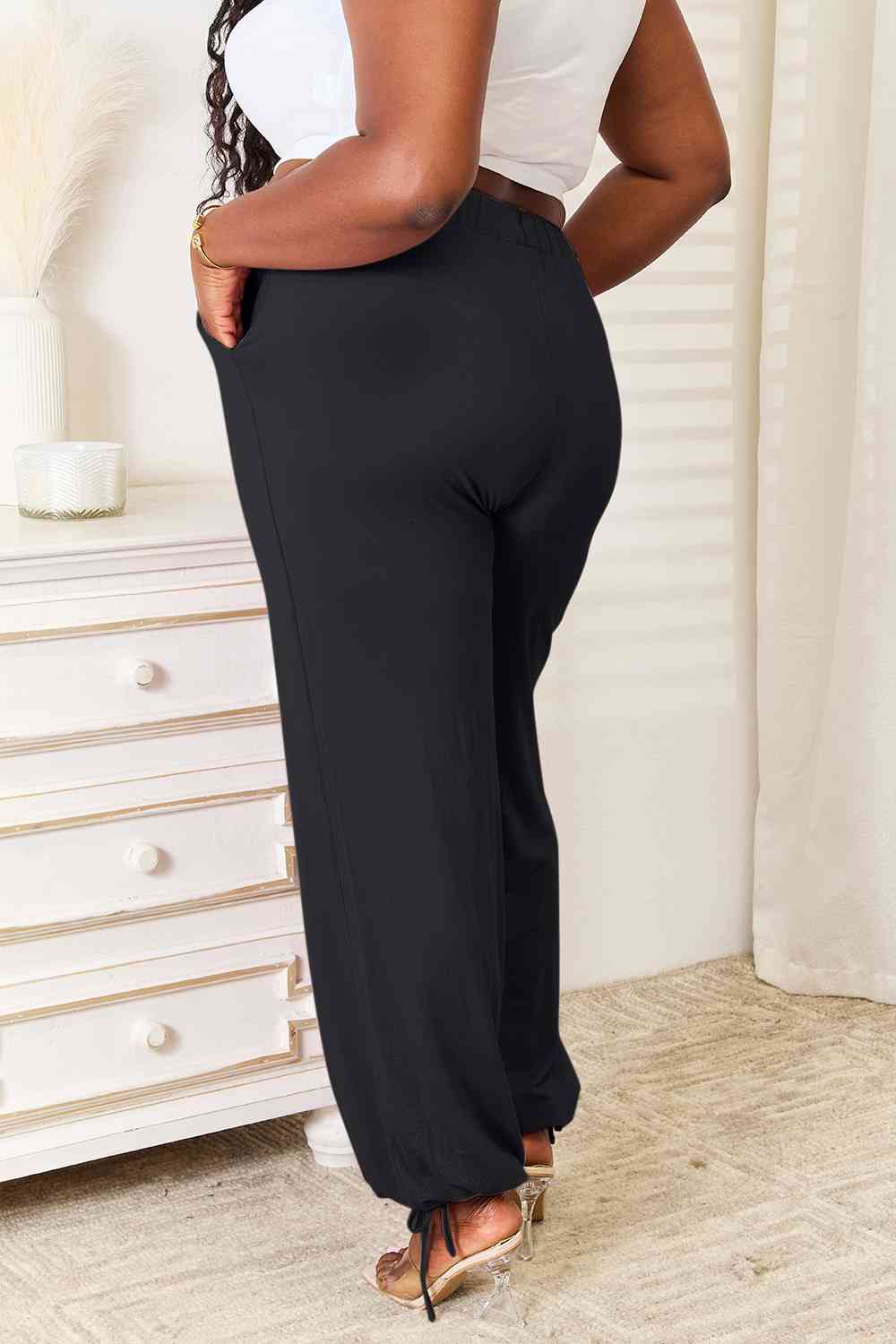 Basic Bae Full Size Soft Rayon Drawstring Waist Pants in black with pockets, showcasing a comfortable fit and stylish design.