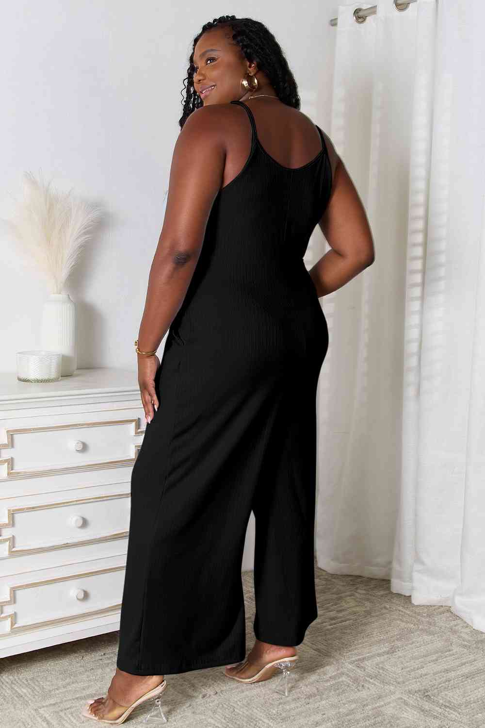 Basic Bae Full Size Spaghetti Strap V-Neck Jumpsuit in black, showcasing its elegant V-neckline and delicate spaghetti straps.