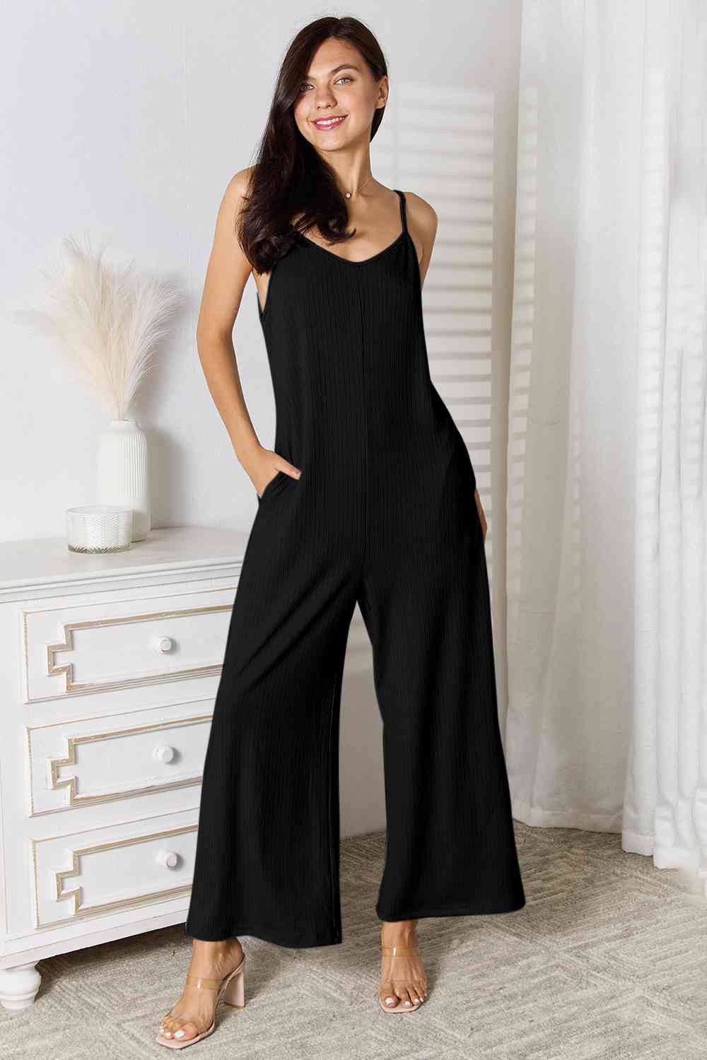 Basic Bae Full Size Spaghetti Strap V-Neck Jumpsuit in black, showcasing its elegant V-neckline and delicate spaghetti straps.