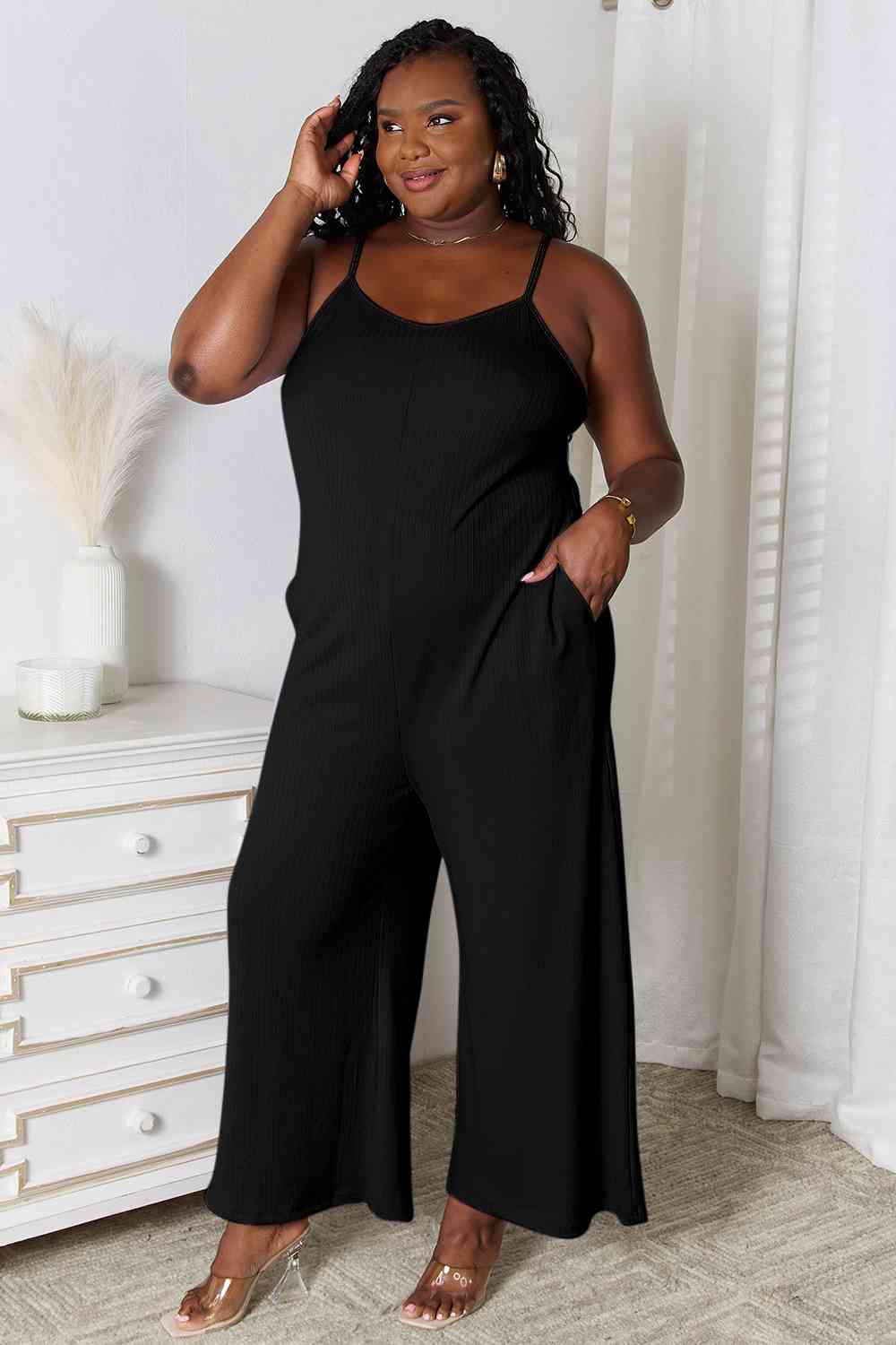 Basic Bae Full Size Spaghetti Strap V-Neck Jumpsuit in black, showcasing its elegant V-neckline and delicate spaghetti straps.