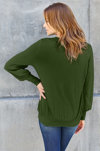 Basic Bae Full Size V-Neck Lantern Sleeve Blouse in soft fabric with elegant lantern sleeves.