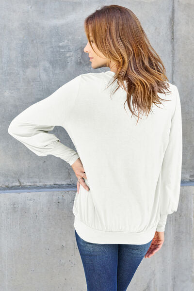 Basic Bae Full Size V-Neck Lantern Sleeve Blouse in soft fabric with elegant lantern sleeves.