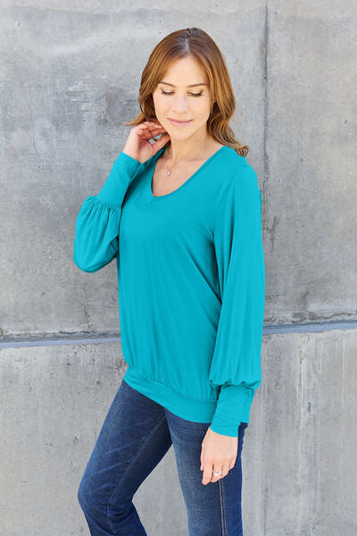 Basic Bae Full Size V-Neck Lantern Sleeve Blouse in soft fabric with elegant lantern sleeves.