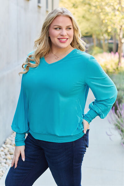 Basic Bae Full Size V-Neck Lantern Sleeve Blouse in soft fabric with elegant lantern sleeves.