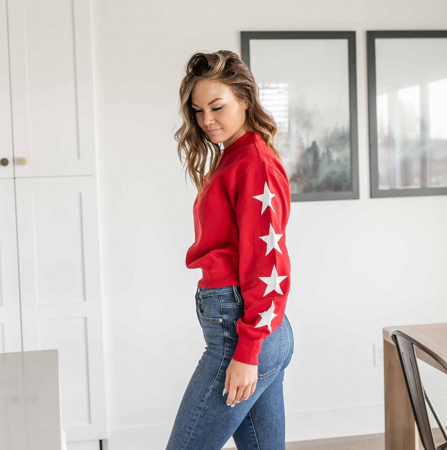 Basic fleece sweatshirt with a star print design, featuring large white stars on the sleeves and a classic round collar.