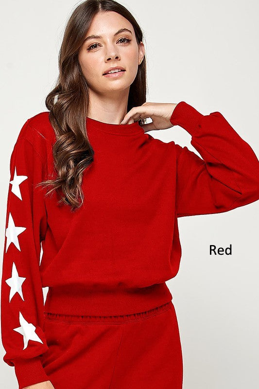 Basic fleece sweatshirt with a star print design, featuring large white stars on the sleeves and a classic round collar.