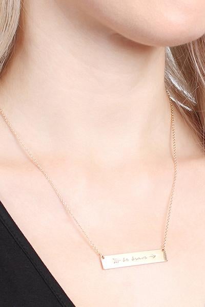 A trendy 'Be Brave' Bar Necklace featuring a rectangular pendant with the phrase 'Be Brave' in gold, rose gold, and silver options.