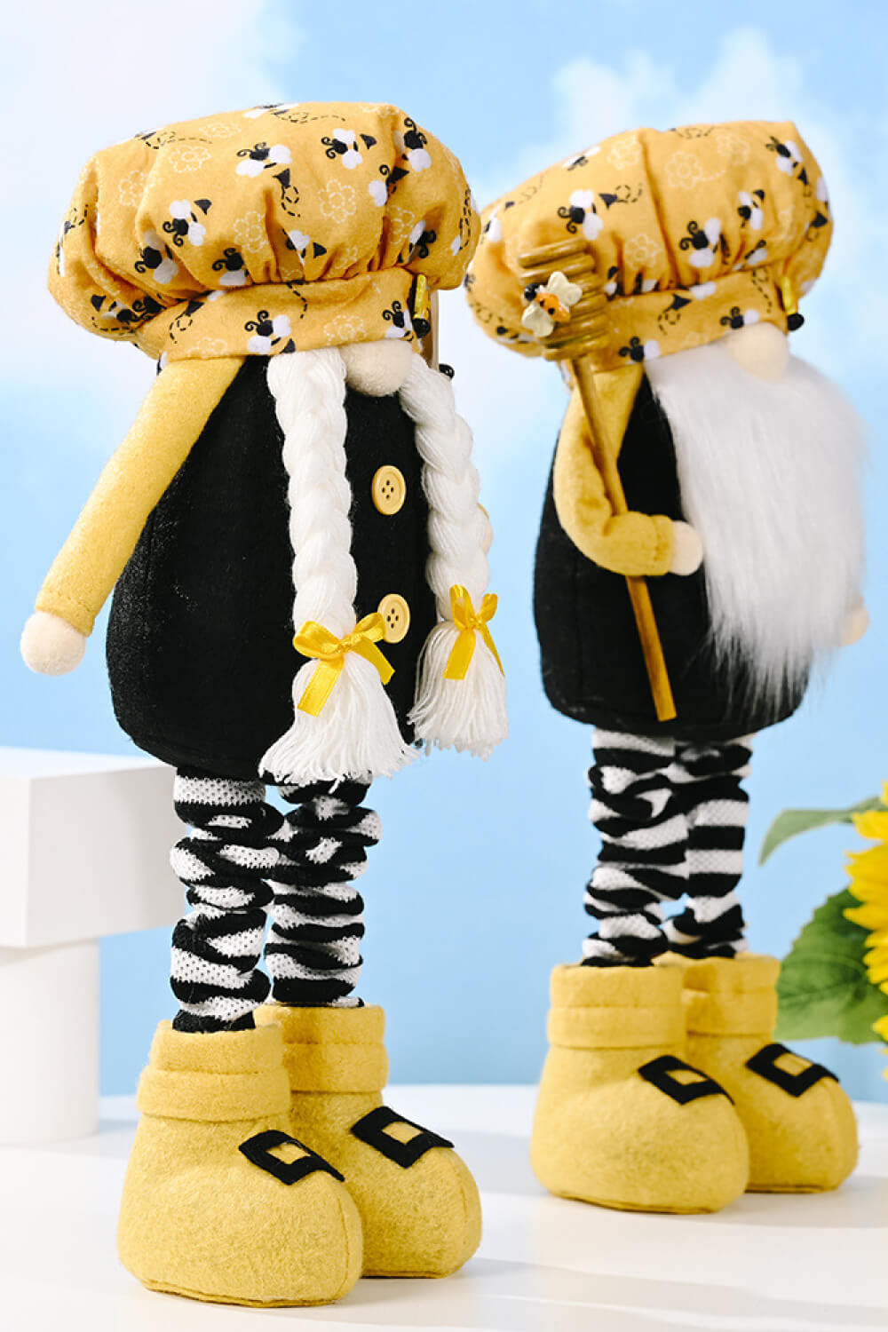 A whimsical Bee Print Telescopic Leg Gnome with adjustable legs, featuring a vibrant bee pattern, perfect for garden or home decor.