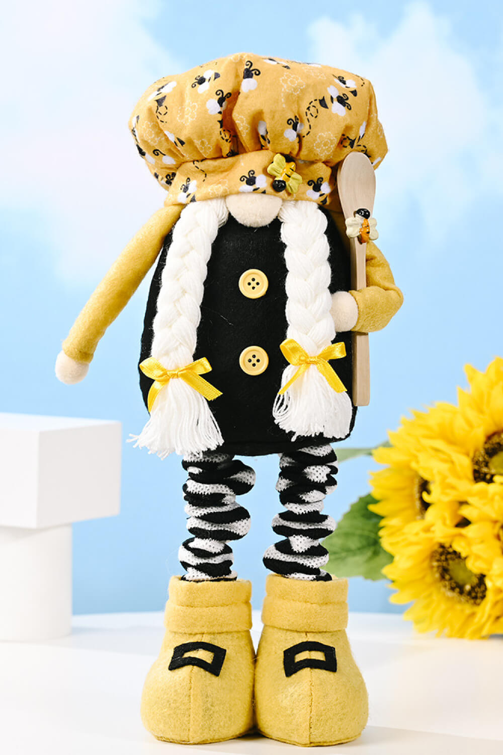 A whimsical Bee Print Telescopic Leg Gnome with adjustable legs, featuring a vibrant bee pattern, perfect for garden or home decor.