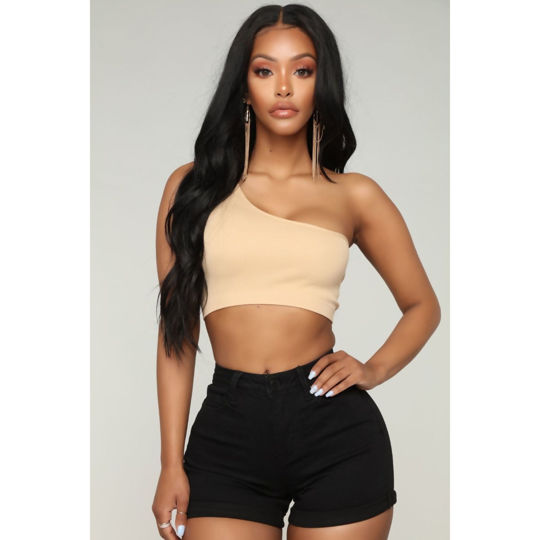 A stylish beige one shoulder crop top made from a soft polyester blend, perfect for casual and dressy occasions.