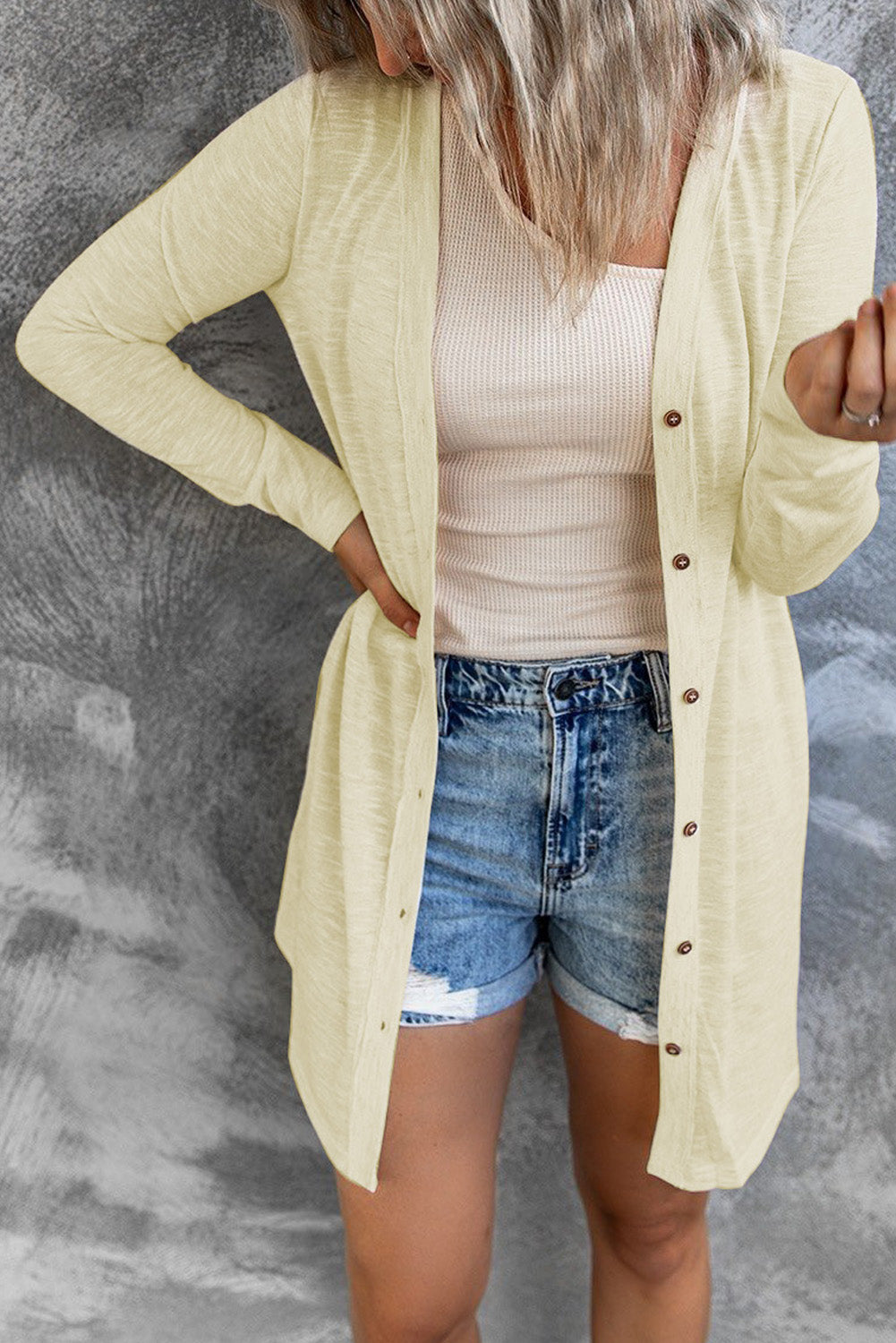 Beige solid color open-front cardigan with buttons, showcasing a loose fit and longline style, perfect for layering in autumn and spring.