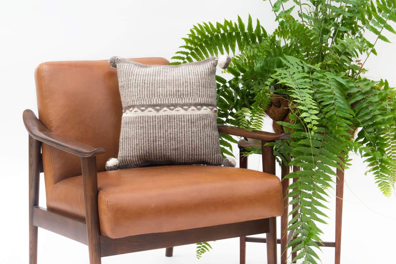 Beige wool pillow cover featuring mountain design, handmade with traditional waist loom technique.