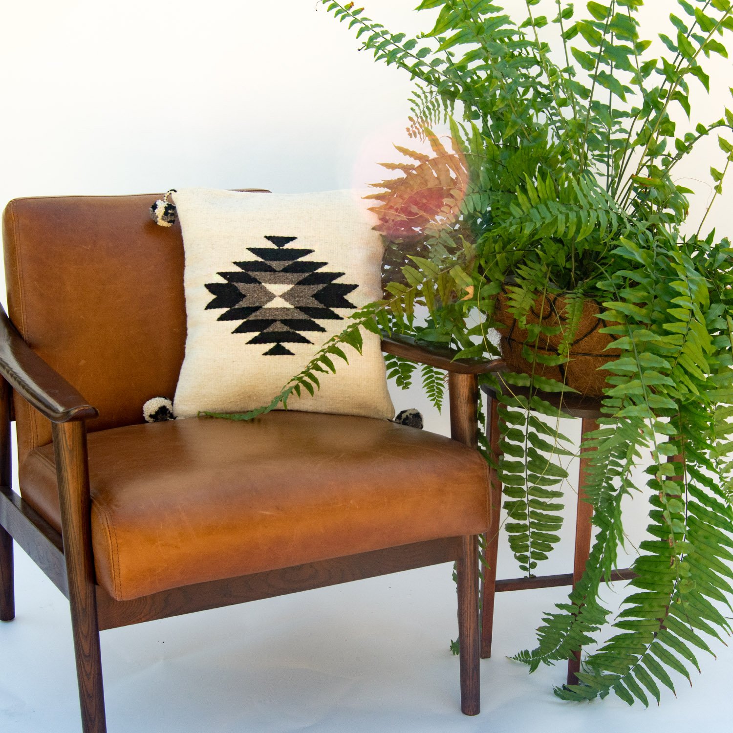 Belegui Black Diamond Wool Pillow Cover featuring a striking black diamond pattern on a white background, handmade in Oaxaca, Mexico.