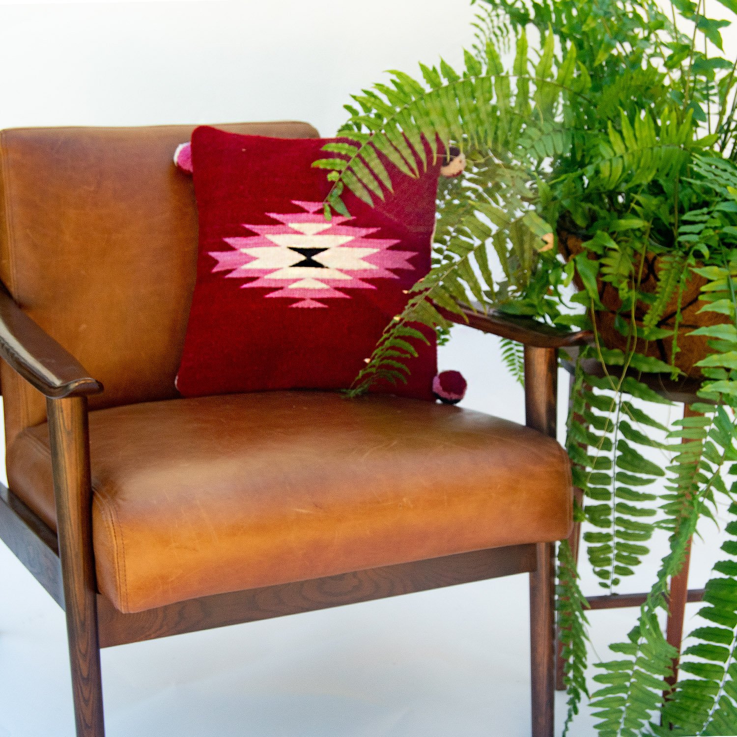 Belegui Wool Pillow Cover featuring a red background with a pink diamond pattern, handmade from heavy-weight wool.