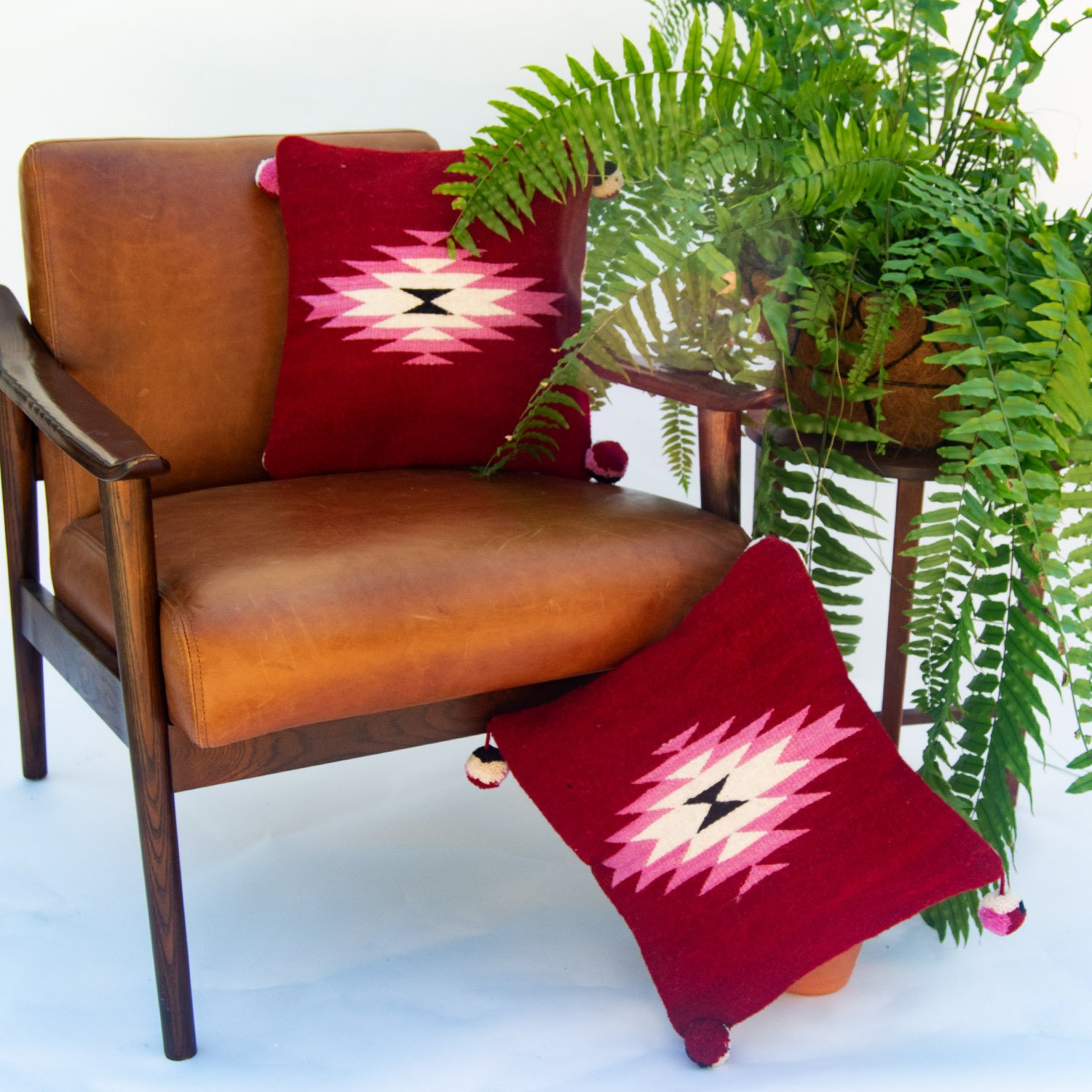 Belegui Wool Pillow Cover featuring a red background with a pink diamond pattern, handmade from heavy-weight wool.