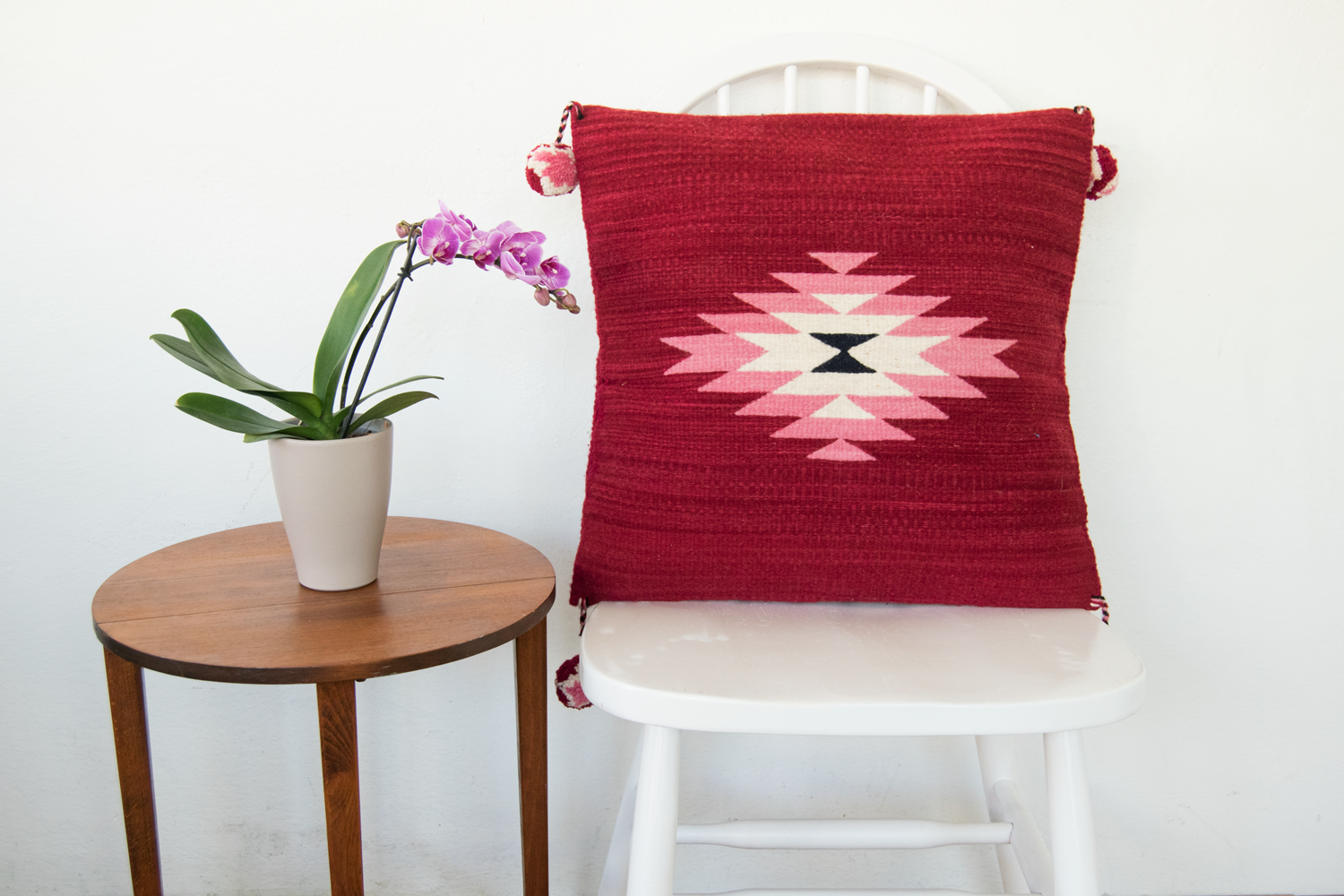 Belegui Wool Pillow Cover featuring a red background with a pink diamond pattern, handmade from heavy-weight wool.