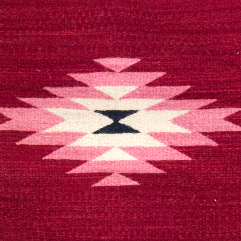 Belegui Wool Pillow Cover featuring a red background with a pink diamond pattern, handmade from heavy-weight wool.