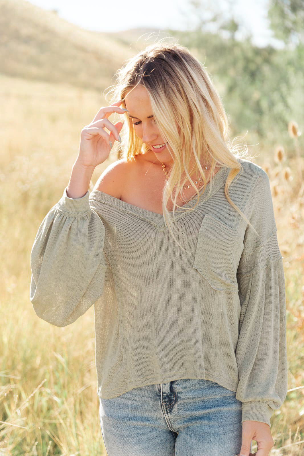 Bellissimo Draped V-Neck Sweater in Olive, featuring a deep V-neckline and raw stitching details, perfect for layering.