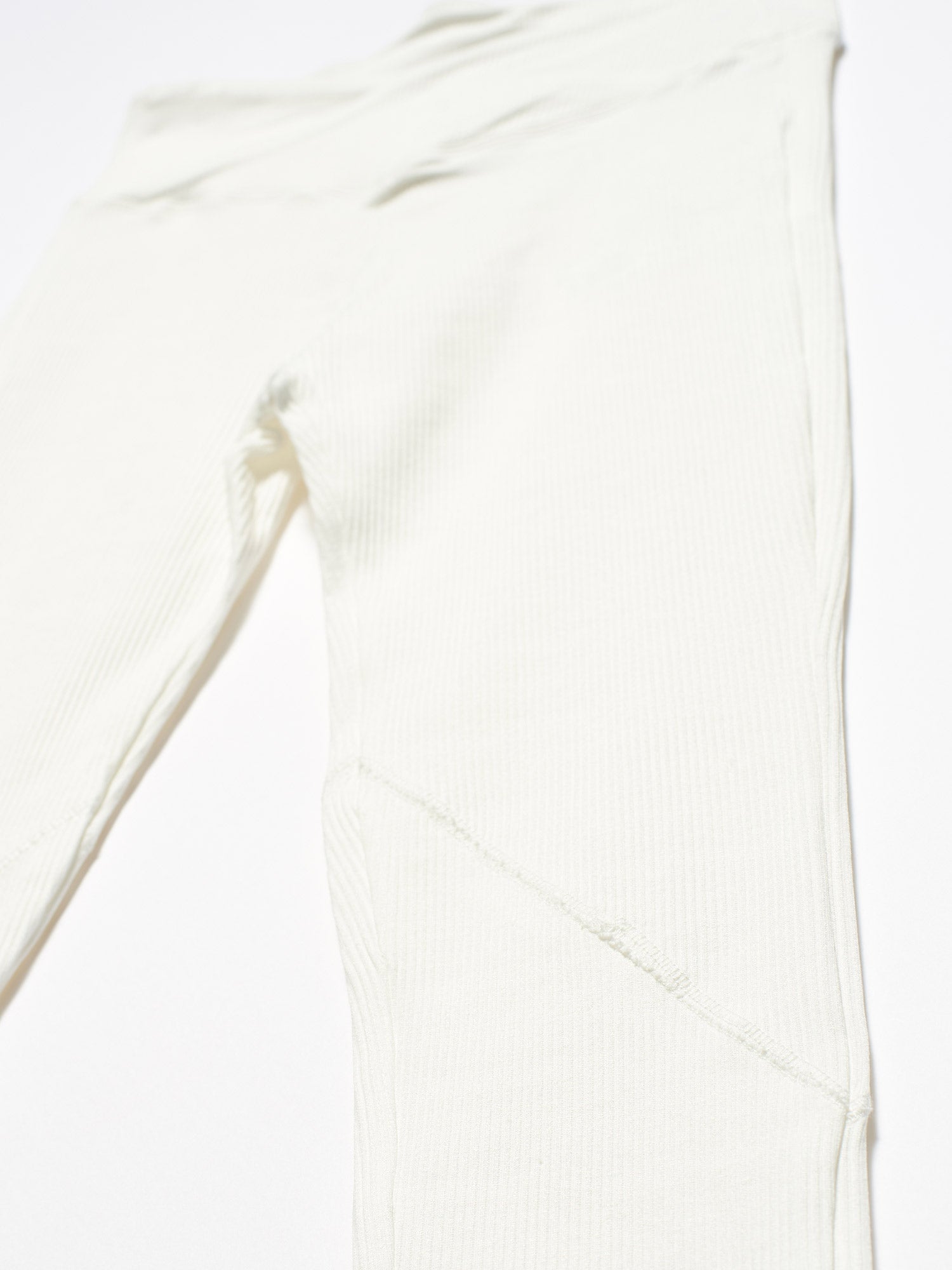 A pair of stylish black belt detailed leggings displayed on a white background, showcasing the unique belt design and soft fabric texture.