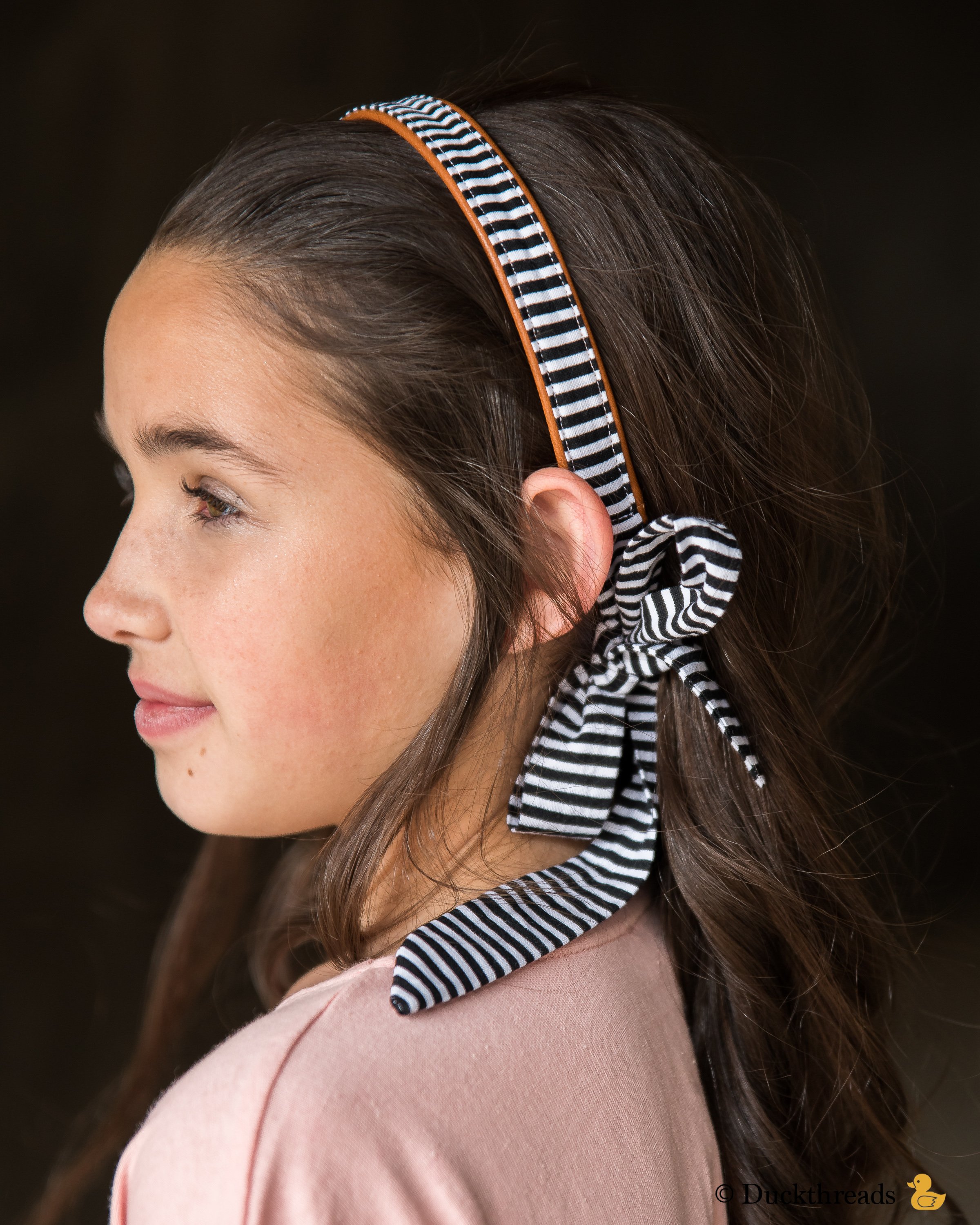 BeltBand reversible belt and headband made from leather and cotton fabric, showcasing black and white stripes.