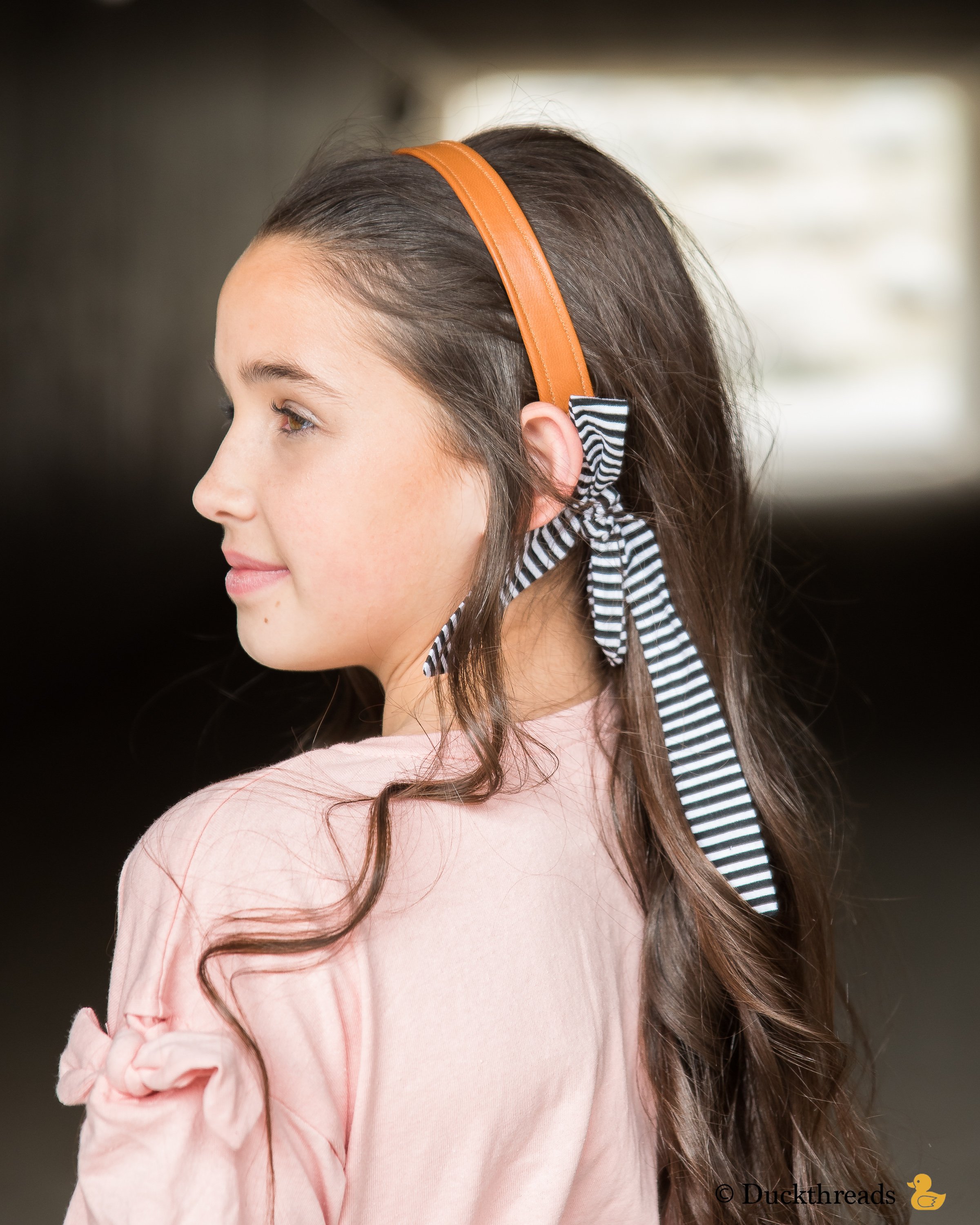 BeltBand reversible belt and headband made from leather and cotton fabric, showcasing black and white stripes.